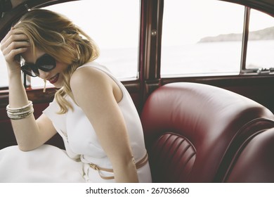 Elegant Woman Smiling In Vintage Car