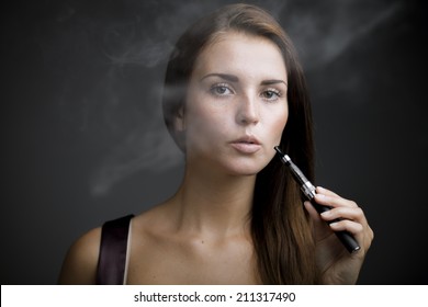 Elegant Woman Smoking E-cigarette With Smoke Portrait