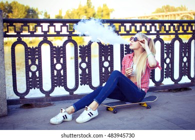 Elegant Woman Smoking E-cigarette With Smoke, Wearing Suit And Hat
