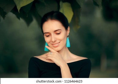 Elegant Woman Wearing Blue Tassel Earrings Fashion Portrait. Beautify stylish female model wearing trendy jewelry
 - Powered by Shutterstock