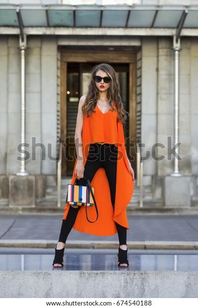 orange top and black jeans