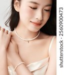 Elegant Woman Wearing a Pearl Necklace and Bracelet Set with a Subtle Smile – Perfect Portrait of Grace and Sophistication in Minimalist Style.