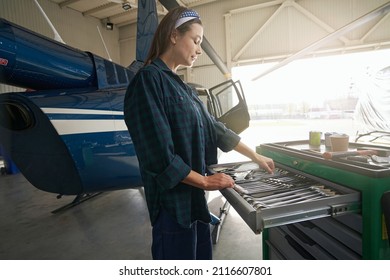 Elegant Woman Working With Special Hand Tools In Aviation Hangar