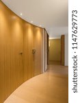 Elegant wooden corridor with spotlights in modern apartment. Nobody inside