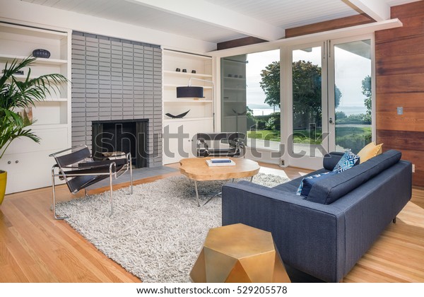 Elegant wooden designer interior with french doors\
and fire place.