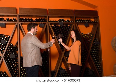 Elegant Young Couple Wine Tasting Sightseeing Tour Visiting Winery Cellar