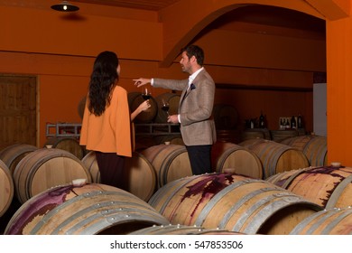 Elegant Young Couple Wine Tasting Sightseeing Tour Visiting Winery Cellar