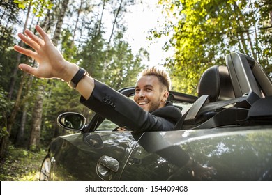 Elegant Young Happy Man In Convertible Car Outdoor. 