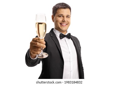 Elegant young man in a suit and bow tie toasting with a glass of sparkling wine isolated on white background