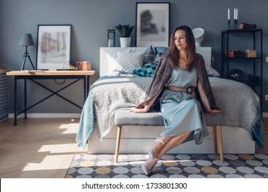 Elegant Young Woman Sitting In Bedroom. Home Interior