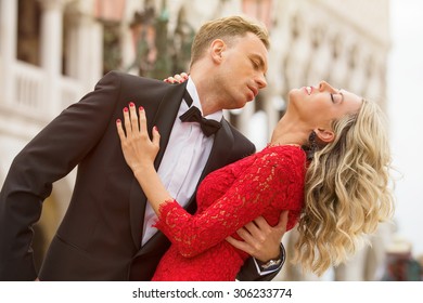 Elegantly Dressed Couple Dancing Outside