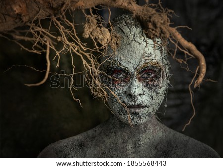 Element earth. The girl in the image of the earth. Fantasy mystical makeup for the image of the earth and man. Girl land.Nature and man.