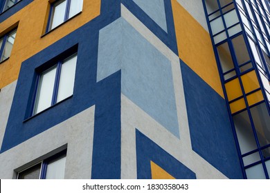 Element of the facade of a modern European building. The facade is painted with multi-colored geometric shapes