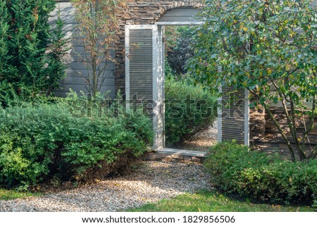 element of landscape design - mirror in the wall od garden - creating the illusion of transition into another space don't existing.  Garden near dacha (because COVID-19 -all year round house)