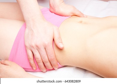 Elementary age girl's pelvis being manipulated by an osteopath - an alternative medicine treatment - Powered by Shutterstock