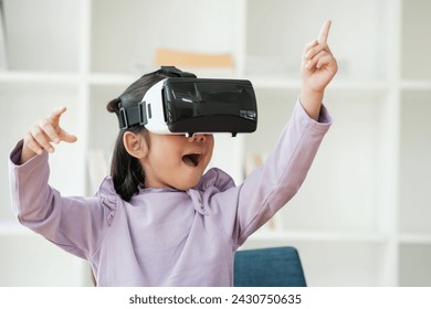 An elementary aged girl uses a virtual reality headset to enhance learning experience with excitement. Marketing for VR products, educational technology content. - Powered by Shutterstock