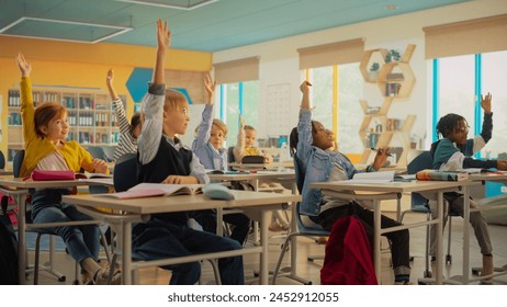 Elementary Classroom with Diverse Children Listening to the Teacher Asking a Question. Everyone Raising Hands in Order to Provide a Correct Answer. Bright Kids in School Receiving Modern Education - Powered by Shutterstock