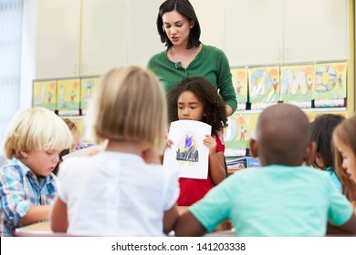 Elementary Pupil Showing Drawing To Classmates In Classroom - Shutterstock ID 141203338