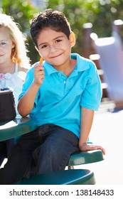 Elementary Pupil Sitting At Table Eating Lunch