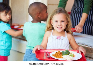 Elementary Pupils Collecting Healthy Lunch In Cafeteria