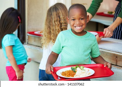 Elementary Pupils Collecting Healthy Lunch In Cafeteria