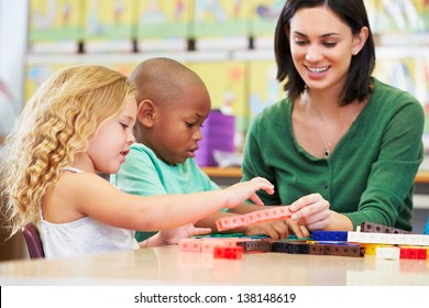 Elementary Pupils Counting With Teacher In Classroom