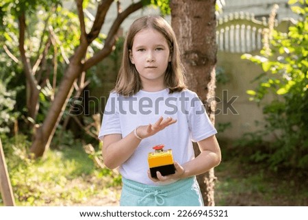 Elementary school age girl about to press a big red industrial emergency stop button, alarm, stopping action, urgency attention simple concept, one person. Advertisement sales, deals, discounts, alert