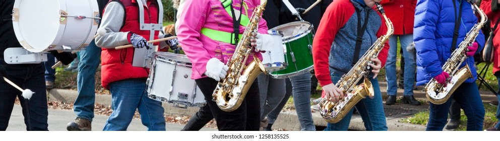 Elementary School Band Performing In Neighborhood Parade.