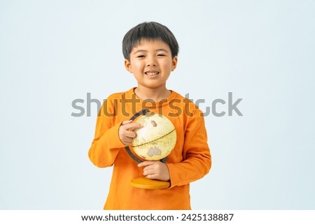 Elementary school boy holding a globe