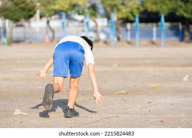 Elementary School Boy Running At The Athletic Meet