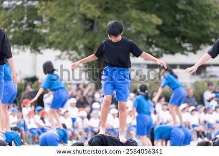 Elementary school boys doing group gymnastics at a sports day
