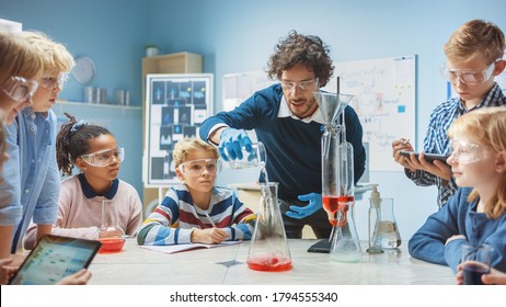 Elementary School Chemistry Classroom: Enthusiastic Teacher Teaches Diverse Group of Children Shows Science Reaction Experiment by Mixing Chemicals in Beaker so they Shoot Foam (Elephant Toothpaste)