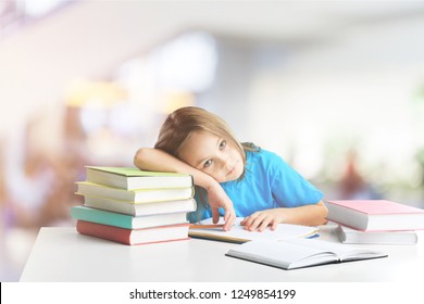 Elementary School Child Thinking While Doing Homework