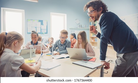 In The Elementary School: Class Of Smart Young Children Work As A Team Using Tablet Computers To Program Wind Turbines. Classroom With Kids Learning About Eco-Friendly Forms Of Renewable Energy