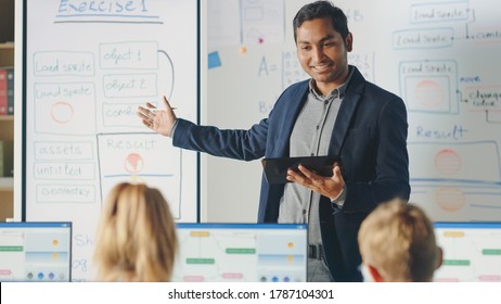 Elementary School Class: Teacher Uses Interactive Digital Whiteboard, Explains Lesson to Diverse Group of Smart Children. Kids getting Modern Education, Learn Computer Science, Software Programming