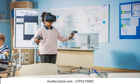 Elementary School Computer Science Class: Cute Girl Wearing Augmented Reality Headset and Using Controllers Learns Lessons in Virtual Reality Excited, Curious and Interested in Knowledge