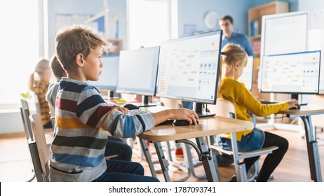 Elementary School Computer Science Classroom: Smart Little Schoolboy Work on Personal Computers, Learn Programming Language for Software Coding. Schoolchildren Getting Modern Education