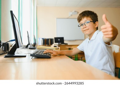 Elementary School Computer Science Classroom, Smart Little Schoolboy Works on Personal Computer.