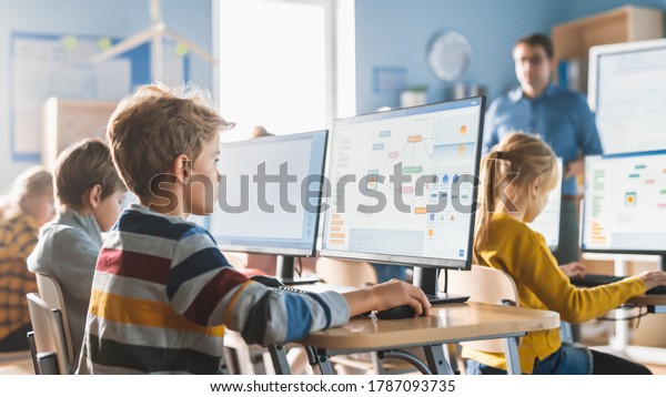 Elementary School\
Computer Science Classroom: Smart Little Schoolboy Work on Personal\
Computers, Learn Programming Language for Software Coding.\
Schoolchildren Getting Modern\
Education