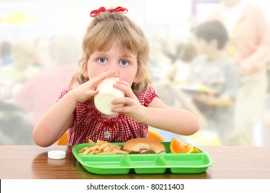 Elementary School Girl Child Having Cafeteria Lunch At Table.