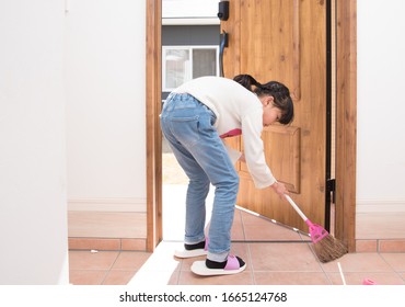 Elementary School Girl Cleaning The Entrance