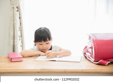 Elementary School Girl Making A Summer Vacation Homework