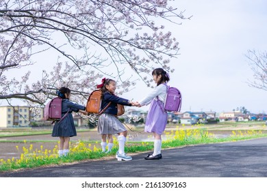 Elementary School Girls Playing On The Way To And From School