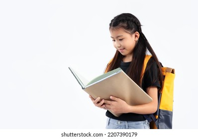 Elementary School Kid In Private Uniform Standing And Reading Book On White Background. Back To School.