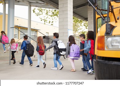 Elementary school kids arrive at school from the school bus