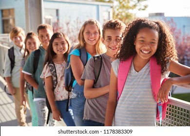 Elementary School Kids With Backpacks Smiling At The Camera