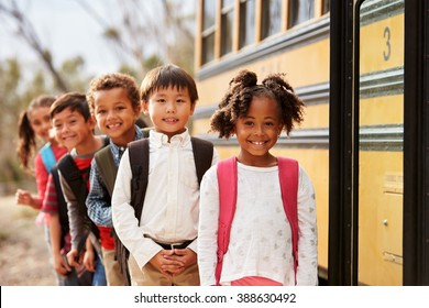 Elementary school kids queueing to get on to a school bus