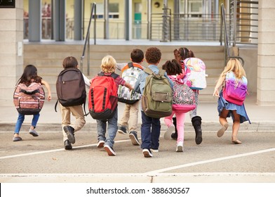 Elementary School Kids Running Into School, Back View