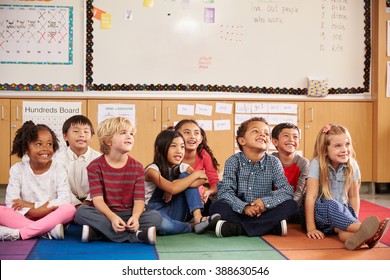 Elementary School Kids Sitting On Classroom Floor