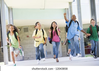 Elementary School Pupils Running Outside Together